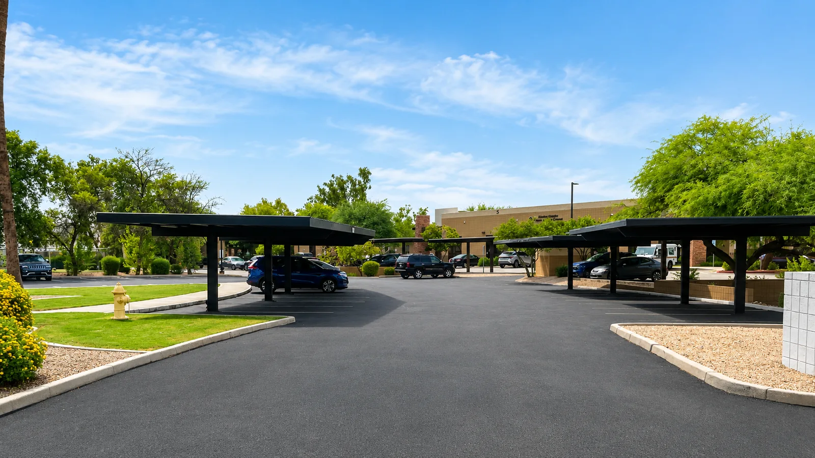 Covered parking canopies in the lot beside the building