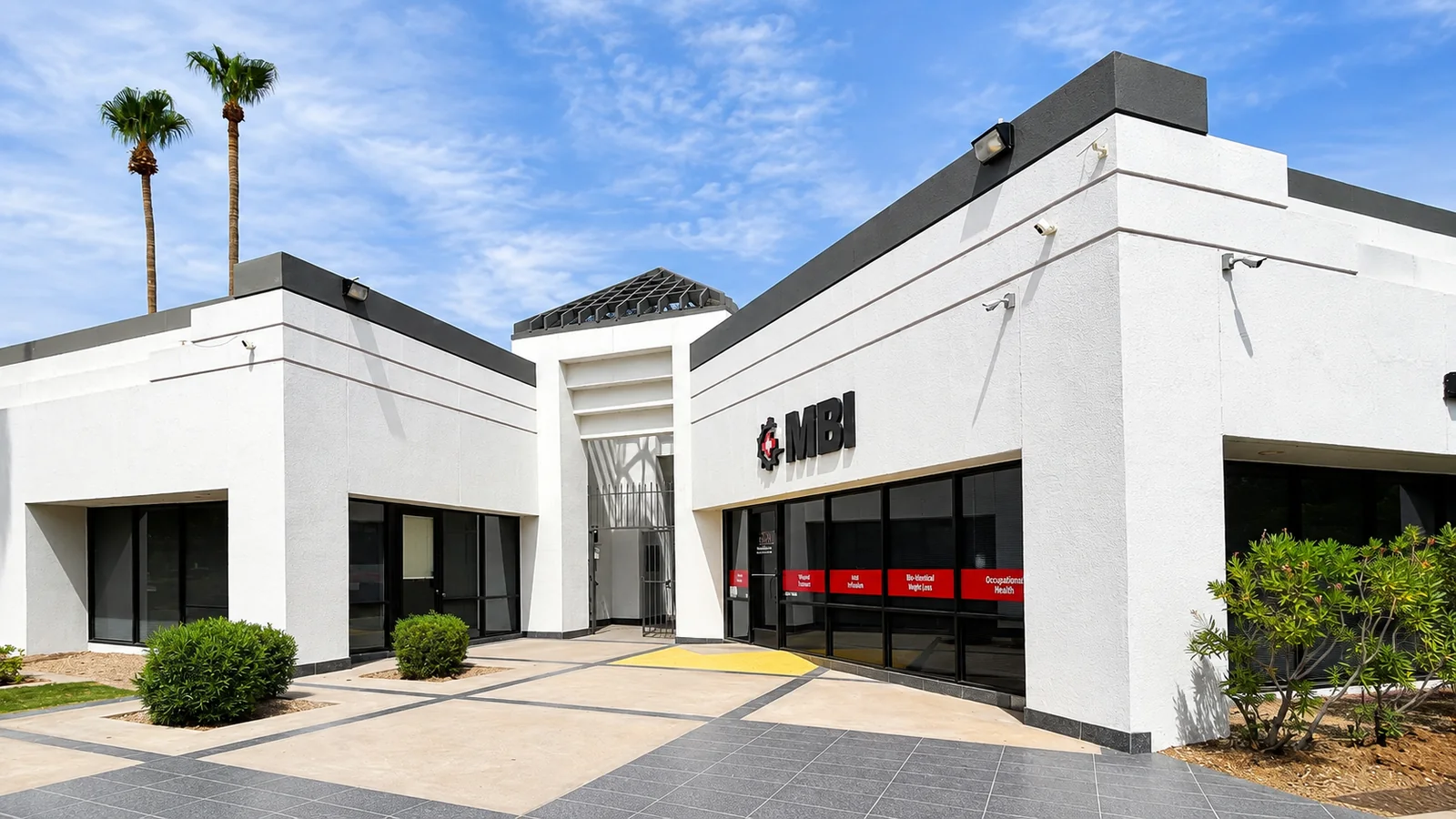 Main entrance with tenant signage and covered walkways