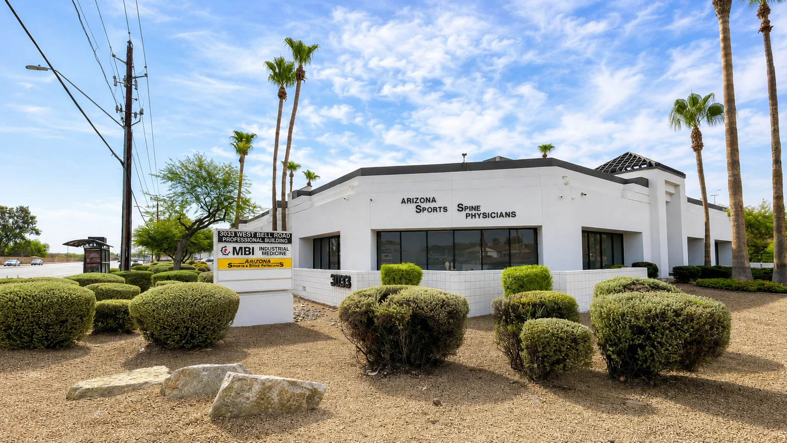 Monument sign reading 3033 West Bell Road Professional Building with MBI Industrial Medicine and Arizona Sports and Spine Physicians