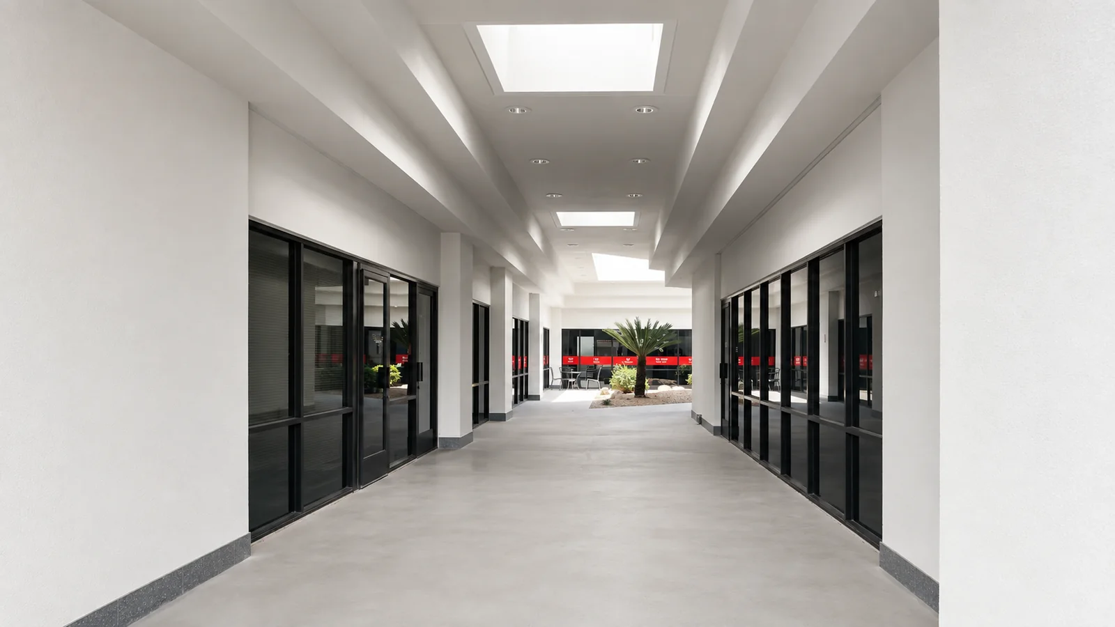 Skylit breezeway running through the building toward the courtyard