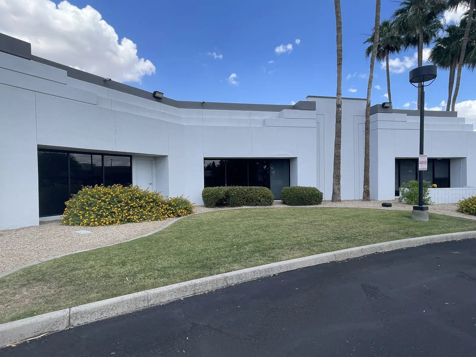 Curved lawn and flowering desert landscaping along the building frontage